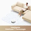 A woman relaxes on a sectional sofa while a robot vacuum cleans the floor in a stylized path. Náhľad obrázku produktu