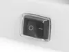 A close-up shot of a black rocker switch with a clear plastic cover on a white surface. Produktbild-Vorschau