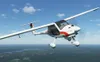 A small white airplane with red and black accents flying in a blue sky over a green landscape. Anteprima dell’immagine prodotto