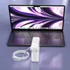 A laptop charger and its cable are placed in front of a laptop. Produktbild-Vorschau