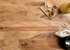 A wooden table with kitchen utensils and a bowl. Produktbild-Vorschau