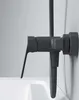 A close-up side view of a dark gray shower faucet mounted on a light gray wall, with the edge of a white bathtub visible below. Produktbild-Vorschau