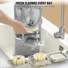 A person is using a commercial french fry cutter with water running over it. There are also cut potato pieces in the foreground. Náhled obrázku produktu