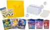 A collection of Pokemon trading cards and accessories, including a yellow binder, several card packs, individual cards, a white box, and a die. Anteprima dell’immagine prodotto