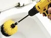 A hand holding a yellow and black drill with a brush attachment, cleaning a white toilet bowl. Voir les images du produit