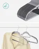 A collage showing a stack of gray hangers and a garment on a hanger. Náhled obrázku produktu