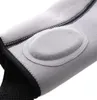 A close-up view of a gray fabric brace with a padded oval insert and black stitching. Podgląd zdjęcia produktu