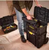 A person is organizing tools in a modular toolbox system. Voir les images du produit