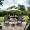 An outdoor patio setting with chairs, a table, and an umbrella, suggesting a place for relaxation or dining. Podgląd zdjęcia produktu