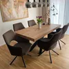 A dining room scene with a wooden table and chairs, a world map on the wall, and decorative items on the table. Produktbild-Vorschau