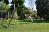 A young person is playing soccer in a backyard with a soccer goal. Anteprima dell’immagine prodotto