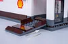 A close-up view of a Lego-style gas station model, focusing on the entrance ramp and a portion of the building. Podgląd zdjęcia produktu
