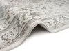 A close-up, angled view of a cream-colored Oriental rug with a vintage pattern in brown and gray. Produktbild-Vorschau