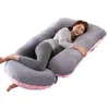 A woman is lying on a U-shaped pregnancy pillow. Náhled obrázku produktu