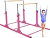 A young girl in a blue leotard stands on one leg next to a pink gymnastics bar set. Anteprima dell’immagine prodotto
