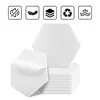 A stack of hexagonal white acoustic panels with one panel peeling off to show its adhesive backing, set against a white background. Above the panels are five icons representing features. Produktbild-Vorschau