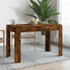 A dining table set up in a room with a plant and chairs. Produktbild-Vorschau