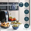 A kitchen scene featuring an air fryer and prepared food, with feature callouts. Produktbild-Vorschau