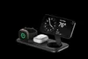 A black charging stand with an Apple Watch, AirPods, and an iPhone displaying a clock and weather. Náhľad obrázku produktu