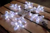 A lit snowflake decoration is placed on a wooden surface. Produktbild-Vorschau