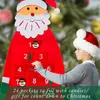 A young boy is reaching for a pocket on a Santa Claus-themed advent calendar. Produktbild-Vorschau