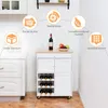 A white kitchen cart with a wooden top, filled with wine bottles and fruit, is shown in a kitchen setting. Feature icons are overlaid on the image. Produktbild-Vorschau