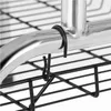 A close-up view of a black wire rack attached to a silver metal bar with a black clip. Produktbild-Vorschau
