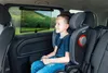 A young boy is sitting in a car seat, looking out the window. Náhled obrázku produktu