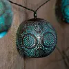 A close-up shot of a decorative string light sphere with intricate metalwork and a blue light emanating from within. Produktbild-Vorschau