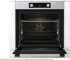 An open oven with racks and baking trays inside. Produktbild-Vorschau