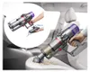 A person is using a cordless vacuum cleaner to clean the interior of a car. An inset image shows how to attach an accessory to the vacuum. Produktbild-Vorschau