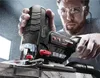 A man is using a jigsaw to cut a piece of wood. Produktbild-Vorschau