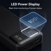 Close-up of a black power bank with an LED display showing 100% charge. Produktbild-Vorschau