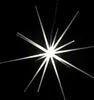 A starburst-shaped light fixture with multiple glowing rods radiating from a central point, set against a black background. Produktbild-Vorschau