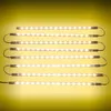 Several LED light strips are arranged horizontally against a yellow gradient background. Produktbild-Vorschau