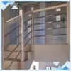A wooden handrail for stairs with silver metal bars, shown installed on a staircase. Náhled obrázku produktu