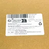 A close-up of a label on a cardboard surface. Produktbild-Vorschau