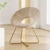A beige velvet accent chair with gold metal legs is shown in a well-lit room. Produktbild-Vorschau