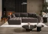 A modern living room with a sectional sofa, coffee tables, and fireplace. Produktbild-Vorschau