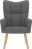 A studio shot of a dark gray fabric armchair with wooden legs. Anteprima dell’immagine prodotto