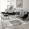 A modern living room with a sofa, chair, and abstract art. Produktbild-Vorschau