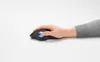 A hand is using a black trackball mouse with a blue ball on a white surface. Anteprima dell’immagine prodotto