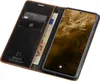 A dark brown leather flip case for a smartphone is shown open, revealing a credit card and banknotes inside, with the smartphone screen displaying the time and date. Produktbild-Vorschau
