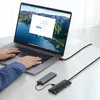 A person's hands are typing on a laptop, with two USB hubs connected to the laptop via cables. Voir les images du produit