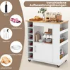 A kitchen cart with various storage solutions, including wine racks, shelves, and a cabinet, displayed with items like wine bottles, glasses, dishes, and bread. Voir les images du produit