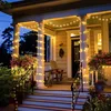 A decorated porch at dusk with string lights. Produktbild-Vorschau