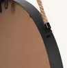 Close-up of the edge of a round mirror with a rope hanger. Produktbild-Vorschau