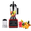 A red blender with a clear pitcher filled with fruit, a separate clear container, a glass of strawberry drink, and a pile of fresh fruit and vegetables on a white background. Produktbild-Vorschau