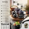 A collection of cookware and kitchen utensils displayed on a wooden surface, with a bowl of rice in the background. Náhled obrázku produktu