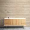 A wooden sideboard with drawers and cabinets sits against a wood-paneled wall. A small potted plant is on top of the sideboard. Anteprima dell’immagine prodotto
